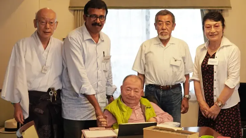 Prof Akira Miyawaki seated center with research colleagues including M R Hari and Prof Kazue Fujiwara at an academic meeting with forest research documents on the table